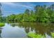 Serene waterfront property showcasing lush greenery and tranquil waters at 975 Mayfield St, Summerville, SC 29485