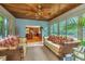 Sunroom with view into kitchen, wicker furniture, and wood ceiling at 975 Mayfield St, Summerville, SC 29485