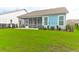 Large backyard with green grass and screened porch at 105 Waxwing Dr, Summerville, SC 29483