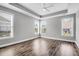 Spacious bedroom with hardwood floors, multiple windows, and tray ceiling at 105 Waxwing Dr, Summerville, SC 29483
