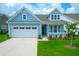 Charming light blue house with white garage and landscaped lawn at 105 Waxwing Dr, Summerville, SC 29483