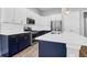 Modern kitchen with white and navy cabinets and stainless steel appliances at 105 Waxwing Dr, Summerville, SC 29483