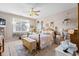 Main bedroom with a wooden bed frame, ceiling fan, and access to a private bathroom at 115 Holly Leaf Ln, Summerville, SC 29486