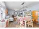 Open concept dining area features a farmhouse table, chandelier, and access to the living room at 115 Holly Leaf Ln, Summerville, SC 29486