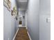 Long hallway with light gray walls and wood flooring at 115 Holly Leaf Ln, Summerville, SC 29486