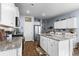 Modern kitchen with white cabinets, granite island and stainless steel appliances at 115 Holly Leaf Ln, Summerville, SC 29486