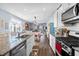 Open kitchen features granite countertops, stainless steel appliances, and ample cabinet space at 115 Holly Leaf Ln, Summerville, SC 29486