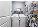 Bright laundry room with washer, dryer and shelving at 115 Holly Leaf Ln, Summerville, SC 29486