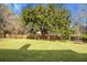 Large backyard with a sprawling oak tree and fenced yard at 1219 Edward Dr, Moncks Corner, SC 29461