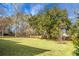 Large backyard with mature trees and a wooden fence at 1219 Edward Dr, Moncks Corner, SC 29461