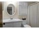 Clean bathroom with white vanity and oval mirror at 1219 Edward Dr, Moncks Corner, SC 29461