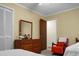 Bedroom with dresser, red chair and twin bed at 1219 Edward Dr, Moncks Corner, SC 29461