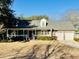 Brick ranch house with 2-car garage, front porch, and mature landscaping at 1219 Edward Dr, Moncks Corner, SC 29461