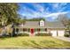 Ranch style brick home with a red door and attached two-car garage at 1219 Edward Dr, Moncks Corner, SC 29461