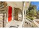 Inviting front porch with white railings and red front door at 1219 Edward Dr, Moncks Corner, SC 29461