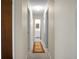 Long hallway with carpet and access to rooms and bathroom at 1219 Edward Dr, Moncks Corner, SC 29461