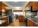 Kitchen boasts wood cabinets, stainless steel appliances, and granite countertops at 1219 Edward Dr, Moncks Corner, SC 29461