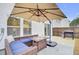 Cozy patio with fire pit, seating, umbrella, and grill at 155 Surfbird Rd, Summerville, SC 29486