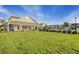 Clubhouse with a manicured lawn and a sidewalk lined with shrubs leading up to it at 155 Surfbird Rd, Summerville, SC 29486
