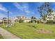Clubhouse with a manicured lawn and a sidewalk lined with shrubs leading up to it at 155 Surfbird Rd, Summerville, SC 29486