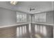 A large, airy common room with wood floors, natural light, and recessed lighting at 155 Surfbird Rd, Summerville, SC 29486