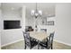 Light and airy dining room with four-chair table and chandelier at 155 Surfbird Rd, Summerville, SC 29486