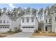 White two-story house with a double-car garage and American flag at 155 Surfbird Rd, Summerville, SC 29486