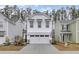 White two-story house with a double-car garage and American flag at 155 Surfbird Rd, Summerville, SC 29486