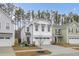 White two-story house with a double-car garage and American flag at 155 Surfbird Rd, Summerville, SC 29486
