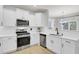 Modern white kitchen with stainless steel appliances at 155 Surfbird Rd, Summerville, SC 29486