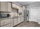 A charming kitchenette features grey cabinets, stainless steel appliances, and sleek granite countertops at 155 Surfbird Rd, Summerville, SC 29486