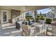 Inviting covered patio with a brick fireplace and comfortable seating area, perfect for relaxing outdoors at 155 Surfbird Rd, Summerville, SC 29486