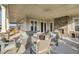 Covered patio with a ceiling fan, brick fireplace, and plenty of comfortable seating at 155 Surfbird Rd, Summerville, SC 29486
