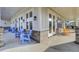Long spacious porch with blue rocking chairs lining the front of the building for relaxing outdoors at 155 Surfbird Rd, Summerville, SC 29486
