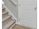 Carpeted stairs with wooden base and white railing at 155 Surfbird Rd, Summerville, SC 29486