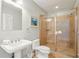 Simple bathroom with walk-in shower and white pedestal sink at 1681 E Ashley Ave # A & B, Folly Beach, SC 29439