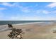 Peaceful beach with rock jetty, offering tranquil ocean views at 1681 E Ashley Ave # A & B, Folly Beach, SC 29439