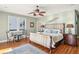 Main bedroom with king-size bed, seating area, and hardwood floors at 1681 E Ashley Ave # A & B, Folly Beach, SC 29439