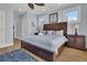 Bedroom with hardwood floors, a ceiling fan, and access to a bathroom at 1681 E Ashley Ave # A & B, Folly Beach, SC 29439