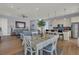 Open concept dining area with adjacent kitchen and hardwood floors at 1681 E Ashley Ave # A & B, Folly Beach, SC 29439