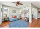 Light-filled living room featuring hardwood floors, a comfy sofa, and a circular rug at 1681 E Ashley Ave # A & B, Folly Beach, SC 29439