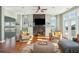 Bright living room with fireplace, hardwood floors, and ocean views at 1681 E Ashley Ave # A & B, Folly Beach, SC 29439