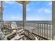 Relaxing ocean view from balcony with chairs at 1681 E Ashley Ave # A & B, Folly Beach, SC 29439