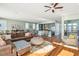 Open floor plan with living and kitchen areas, hardwood floors, and ceiling fan at 1681 E Ashley Ave # A & B, Folly Beach, SC 29439