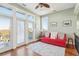 Bright sitting area with red couch, hardwood floors, and ocean views at 1681 E Ashley Ave # A & B, Folly Beach, SC 29439