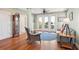 Bright sunroom with hardwood floors, wicker chair, and access to a balcony at 1681 E Ashley Ave # A & B, Folly Beach, SC 29439