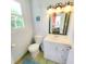 Small bathroom with single vanity and toilet at 209 Palmetto Blvd, Edisto Beach, SC 29438