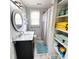 Clean bathroom with marble vanity, shower, linen closet, and light blue accents at 209 Palmetto Blvd, Edisto Beach, SC 29438