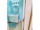 Clean bathroom with light blue walls and a round mirror at 209 Palmetto Blvd, Edisto Beach, SC 29438