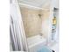 Updated bathroom with beige tile, shower/tub combo, and ample storage at 209 Palmetto Blvd, Edisto Beach, SC 29438